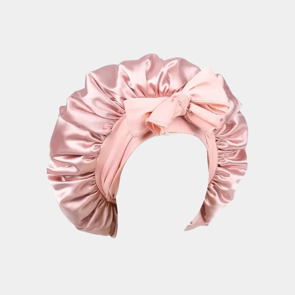 Bonnet de nuit en satin rose pâle avec nœud ajustable